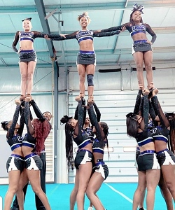 Cheerleaders practicing in a gymnasium